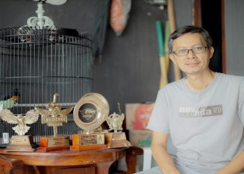 Dosen FKI UMS Dedi Gunawan, S.T., M.Sc., Ph.D., beserta beberapa trophy lomba kicau burung. Foto: Ist.